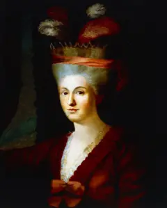 Maria Anna Mozart, Nannerl, posa com um vestido vermelho com bordados brancos no decote. Na cabeça, usa uma espécie de chapéu com penas.
