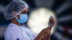 A health worker prepares doses of the AstraZeneca vaccine against Covid-19 (coronavirus) today, in the block of Portela, one of the most traditional carnival groups in Rio de Janeiro, Brazil on 20 April 2021