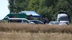 Members of the military and emergency services work near a crater in a field left by an unidentified object that appears to be a Russian missile, Polish Prime Minister Donald Tusk said on Thursday, near the village of Tarnawa-Kolonia in Lublin province, Poland, July 30, 2026. 