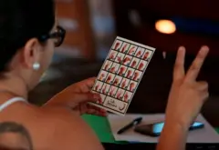 Woman reading a sign language card