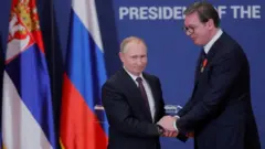 Russian President Vladimir Putin decorates Serbian President Aleksandar Vucic with an order of Alexander Nevsky after their meeting in Belgrade in January