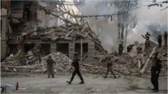 Rescuers and servicemen work at a school building damaged by a Russian military strike, amid Russia"s invasion on Ukraine, in Kramatorsk, in Donetsk region, Ukraine