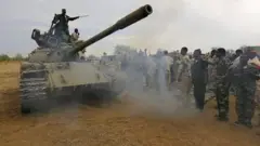 Sudan government troops with a tank