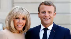 Brigitte Macron (left) and her husband Emmanuel