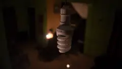 A CFL bulb in a dimly lit background.