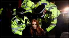 Police at Clapham Common handcuff a woman