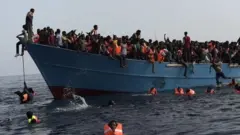A boat full of migrants is seeing on the Mediterranean Sea