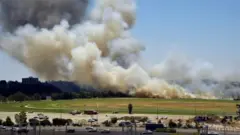 A bushfire outside the Perth Stadium as a heatwave hits Western Australia
