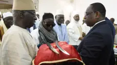 Senegal President Macky Sall (R) receives the sword El Hadj Omar Tall during a ceremony with French Prime Minister Edouard Philippe at the Palace of the Republic in Dakar, Senegal, on November 17, 2019.