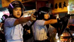 Police pointing guns