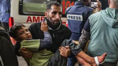 A wounded child is brought into a hospital in Gaza