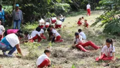 Crianças plantando árvores