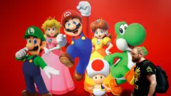 A visitor walks by "Super Mario" video-game poster from the Super Mario video game series created by Nintendo during the 'Paris Games Week' at Parc des Expositions Porte de Versailles on October 23, 2024 in Paris