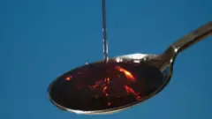 Cough syrup inside spoon