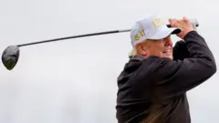 Donald Trump tees off at his golf course near Aberdeen