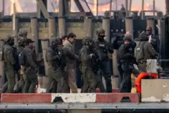 Captured Venezuelan President Nicolas Maduro is escorted, as he heads towards the Daniel Patrick Moynihan United States Courthouse in Manhattan for an initial appearance to face U.S. federal charges including narco-terrorism, conspiracy, drug trafficking, money laundering and others, at Downtown Manhattan Heliport, in New York City, U.S., January 5, 2026.