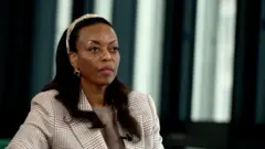 Former Nigerian minister of petroleum resources Diezani Alison-Madueke wear check suit ontop brown dress