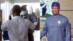 Checkpoint for airpot wit man raising im hand and festus Keyamo on di left