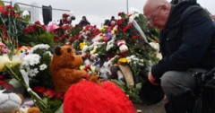 A man mourns at a makeshift memorial for victims of the attack at the Crocus concert hall