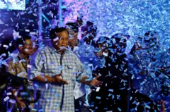 Presidential candidate Prabowo Subianto reacts while dancing as he claims victory after unofficial vote counts during an event to watch the results of the general election in Jakarta, Indonesia,