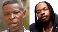 Baba Mohbad àti Naira Marley duro papọ, baba Mohbad wọ aṣọ aláwọ̀ búlúù nigbati Naira Marley wọ aṣọ dúdú, tó sì di irun rẹ. 
