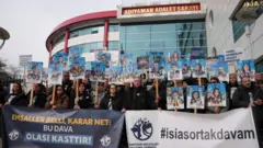 Ellerinde depremde ölen çocuklarının fotoğraflarını tutan aileler Adıyaman adliyesi önünde sessizce duruyor.