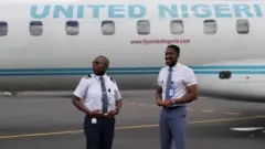Pipo stand near plane