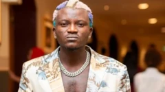 Portable kún irun rẹ̀ ní ọ̀pọ̀ àwọ̀, ó wọ ẹ̀gbà ọrùn, ó ń wo ọ̀ọ́kán 