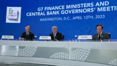 Japanese Finance Vice Minister Masato Kanda, Finance Minister Shunichi Suzuki and Bank of Japan Governor Kazuo Ueda speak during a news conference at the annual spring meetings of the World Bank Group and the International Monetary Fund (IMF) at the IMF headquarters on April 12, 2023 in Washington, DC. 