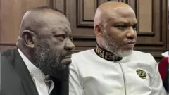 Aloy Ejimakor on black wit Nnamdi Kanu on white for court