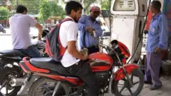 పెట్రోలు పోయించుకుంటున్న వాహనదారులు