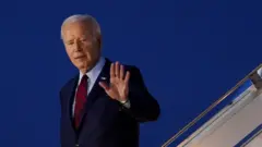 Joe Biden walks down the steps of Air Force One