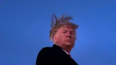 US President Donald Trump boards Air Force One at Andrews Air Force Base as the US House of Representatives debates his impeachment on December 18, 2019, in Maryland.