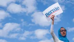 A supporter of Democratic presidential hopeful Vermont Senator Bernie Sanders (not pictured) holds up a sign