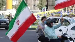 Scooter rally in Tehran with Iranian flags
