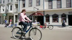 Mulher andando de bicicleta na ilha
