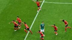 South Korea celebrate their first goal