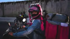 A delivery worker takes part in a demonstration against delivery apps on 25 July, in Belo Horizonte, Brazil