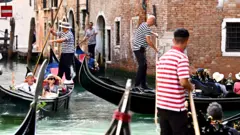 Tourist enjoy gondola rides on 3 September 2023 in Venice, Italy