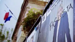 A Marine Le Pen poster defaced with the word "fascista" in France