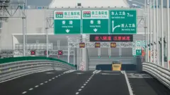 A bus is driven into the under-sea tunnel of the West Artificial Island towards Hong Kong on a section of the Hong Kong-Macau-Zhuhai Bridge on October 24, 2018. - The world's longest sea bridge connecting Hong Kong, Macau and mainland China opened to traffic on October 24 after President Xi Jinping announced its launch at an official ceremony on October 23.