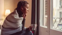 Woman looking out of window