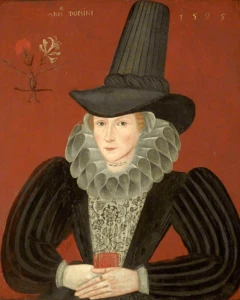 Retrato renacentista con fondo rojo, mujer vestida con traje negro de mangas acanaladas, gran cuello de volados blancos y sombrero alto.