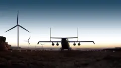 Imagem conceitual mostrando um WindRunner em uma pista acidentada ao lado de moinhos de vento