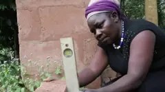 Woman as she dey lay bricks