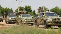 Nigerian soldiers patrol on October 12, 2019, after gunmen suspected of belonging to the Islamic State West Africa Province (ISWAP) group raided the village of Tungushe, killing a soldier and three residents