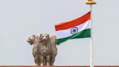 ভারতের সংসদ ভবনের চূড়ায় জাতীয় প্রতীক আর জাতীয় পতাকা উড়ছে