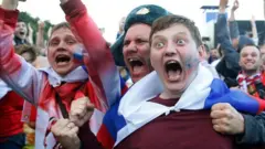 Russian fans celebrate in Moscow after Russia beat Spain to progress to the quarter-finals at the 2018 World Cup. Photo: 1 July 2022