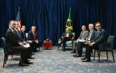 Lula e Trump, ao lado de suas comitivas, durante encontro na Malásia em outubro
