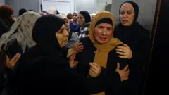 رمله ته نژدې د جواد ریماوي او تهفیر ریماوي خپلوان خاورو ته د دوی له سپارلو مخکې راټول شوي وو.